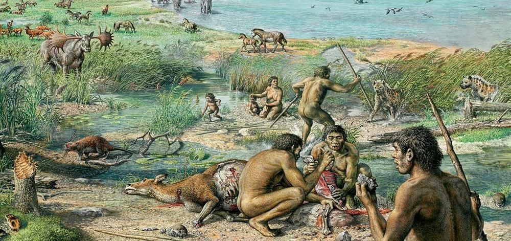 Early humans butcher an animal amid grasslands and near turquoise waters. Animals roam the grassland, children play in the waters and a man raises a spear at animals that look like hyenas