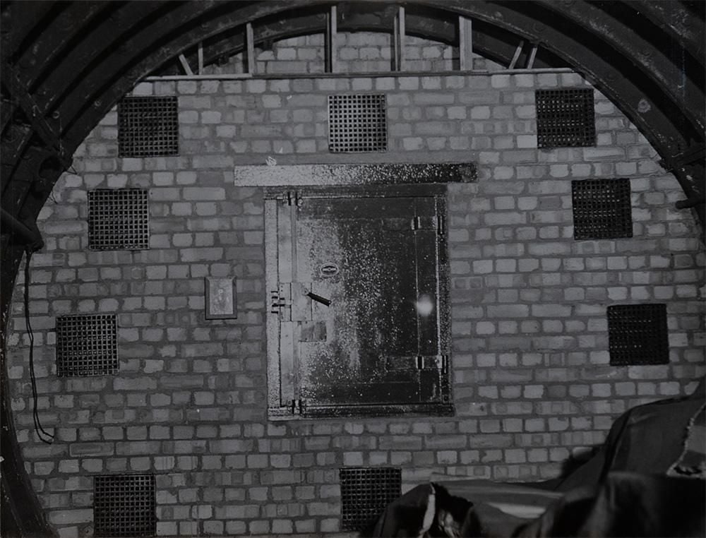 A tube tunnel bricked up with ventilation holes and a secure door