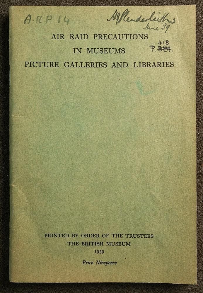 The green cover of a book with the title Air Raid Precautions in Museums Picture Galleries And Libraries, with H Plenderleith June '39 handwritten in top right corner