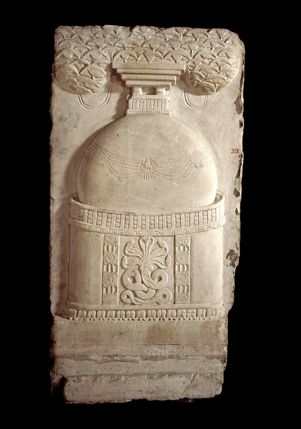 Limestone carving of a snake with five heads guarding a Buddhist shrine.