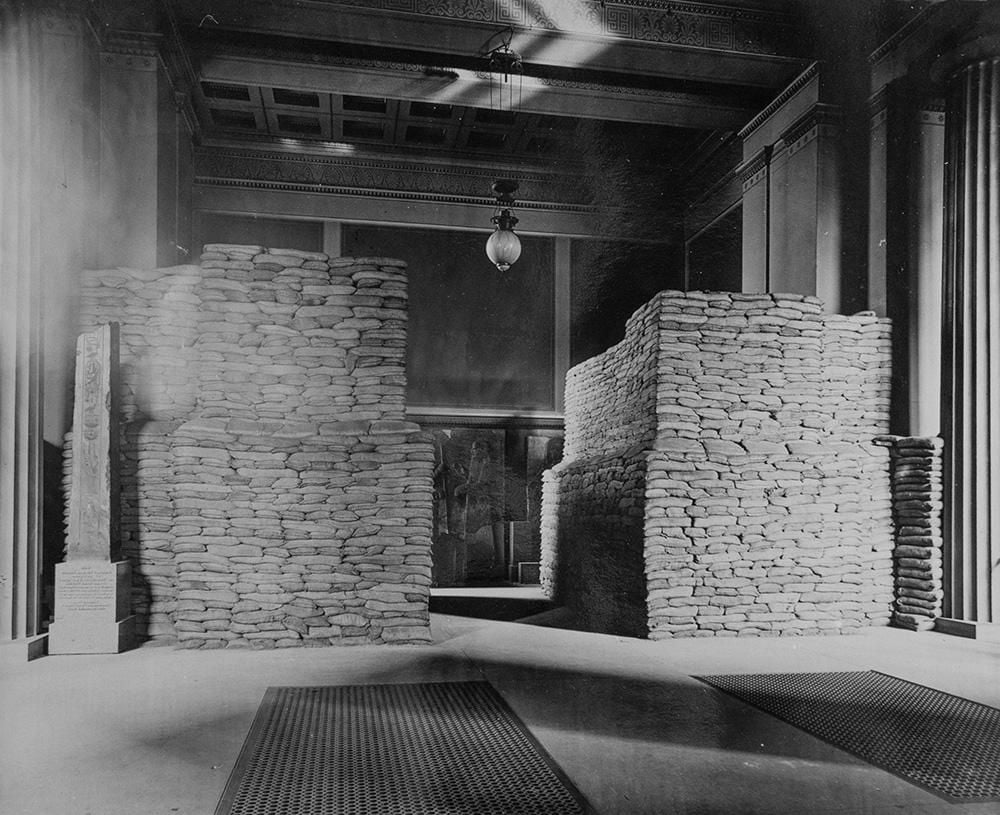 Two huge towers of sandbags protect sculptures in a gallery