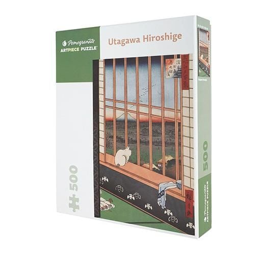 The box of of a jigsaw puzzle with an image of a cat staring out of a window at fields beyond with Mount Fuji on the horizon
