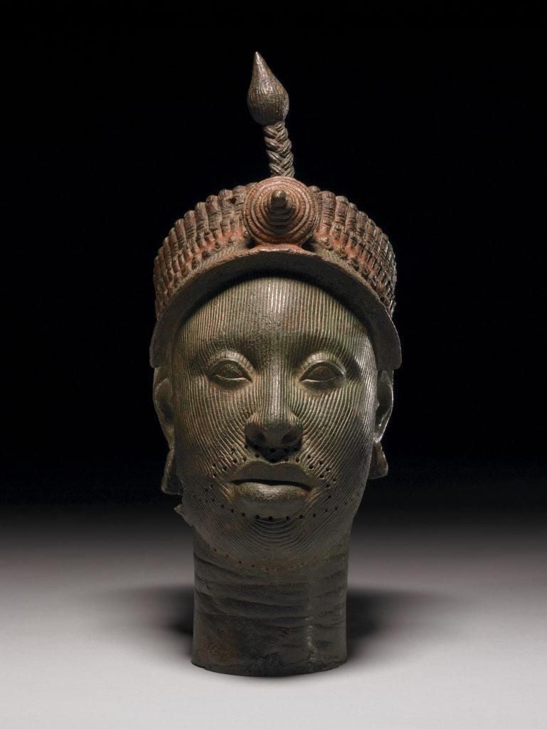 Brass head cast using the lost wax technique, a little under life size, in a naturalistic style. Headdress, suggesting a crown, of complex construction